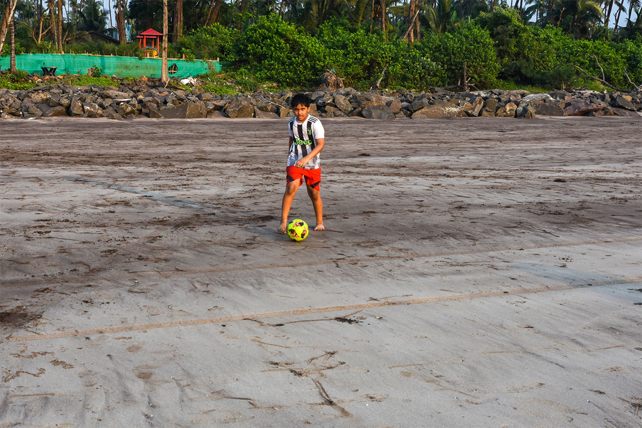 Playing Football on the beach