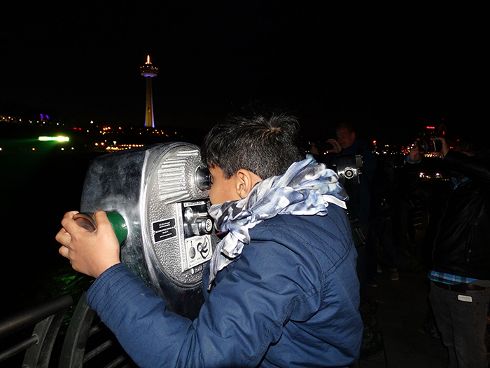 Child watching Niagara Falls at night